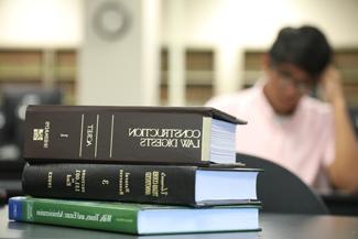 Stack of legal books sitting on desk